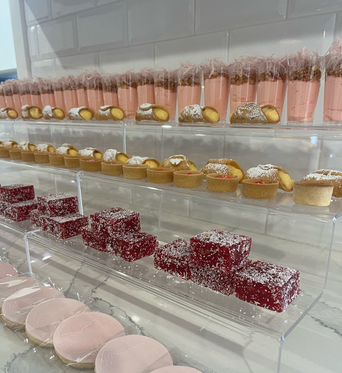 Cup cakes on display using 3 tier acrylic risers.