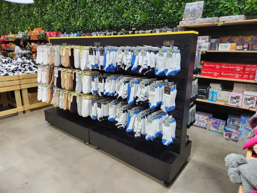 Merchandise displayed using slatwall gondola and hooks in a retail store.