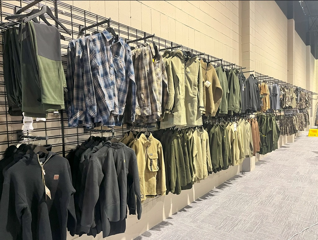 Clothes on display in a hunting clothing shop using Dinya Designs's Grid Mesh Panels