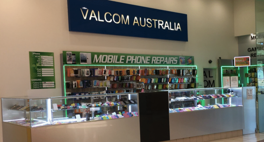 Mobile accessories on display using slatwall panels and hooks in a mobile shop.