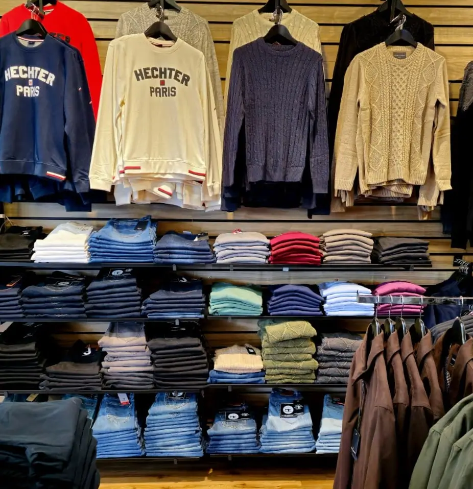 Clothes on glass shelves fitted to Dinya slatwall