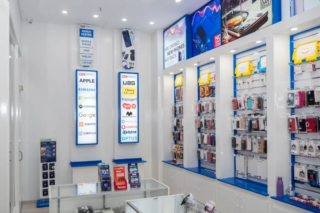 Wall-mounted white slatwall panels displaying phone cases and mobile accessories at GR Phones Adelaide CBD.