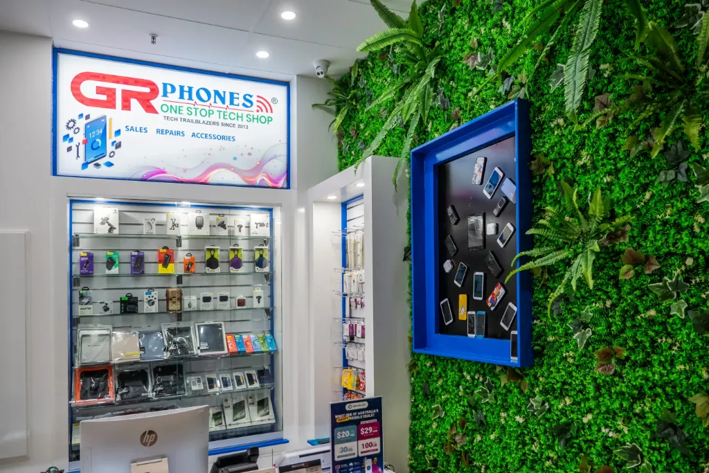 White slatwall display wall with mobile accessories and GR Phones branding inside the Adelaide CBD store.