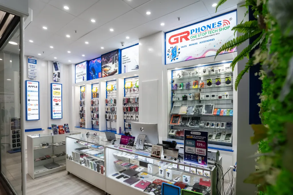 Overview of the GR Phones Adelaide CBD retail fitout featuring white slatwall panels, slatwall hooks, glass display cabinets, and organised phone accessories displays.
