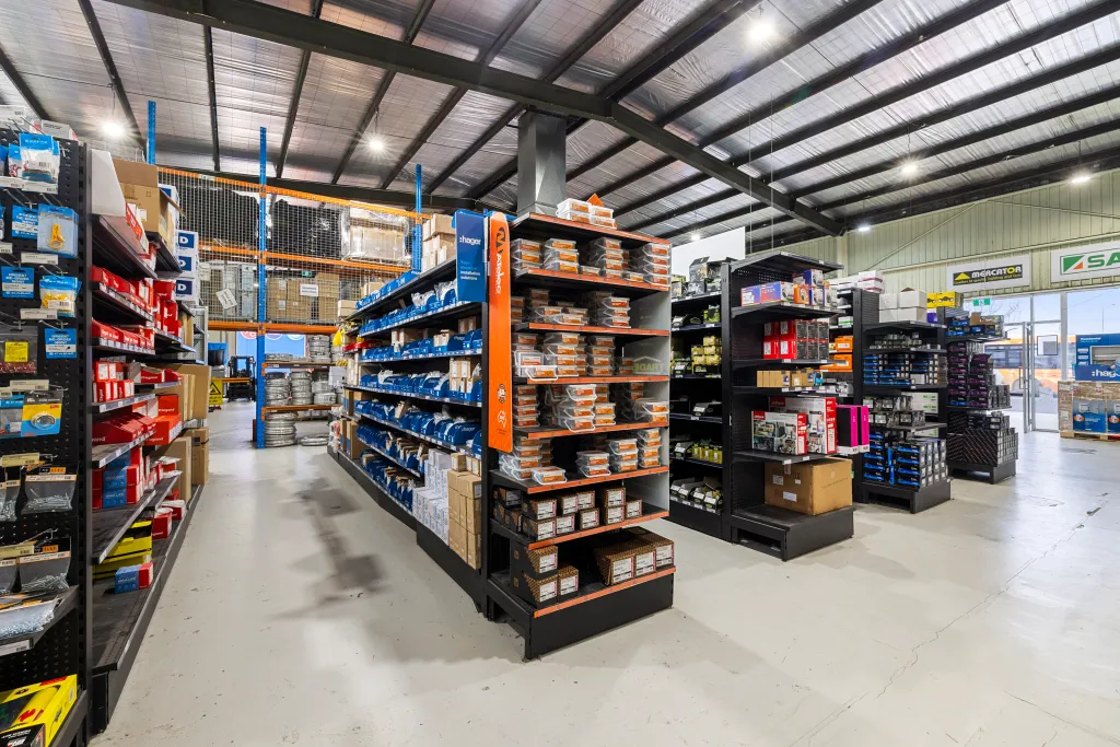 Black volcano board gondola shelving displaying organised electrical products in the AWM Airport West trade warehouse in Melbourne.