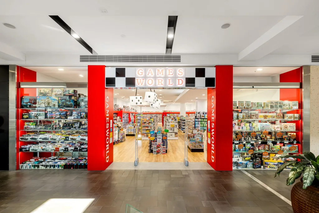 Games World Doncaster specialty games and toy store in Melbourne, featuring a complete retail fitout with white plain panel gondola shelving and glass display cabinets.