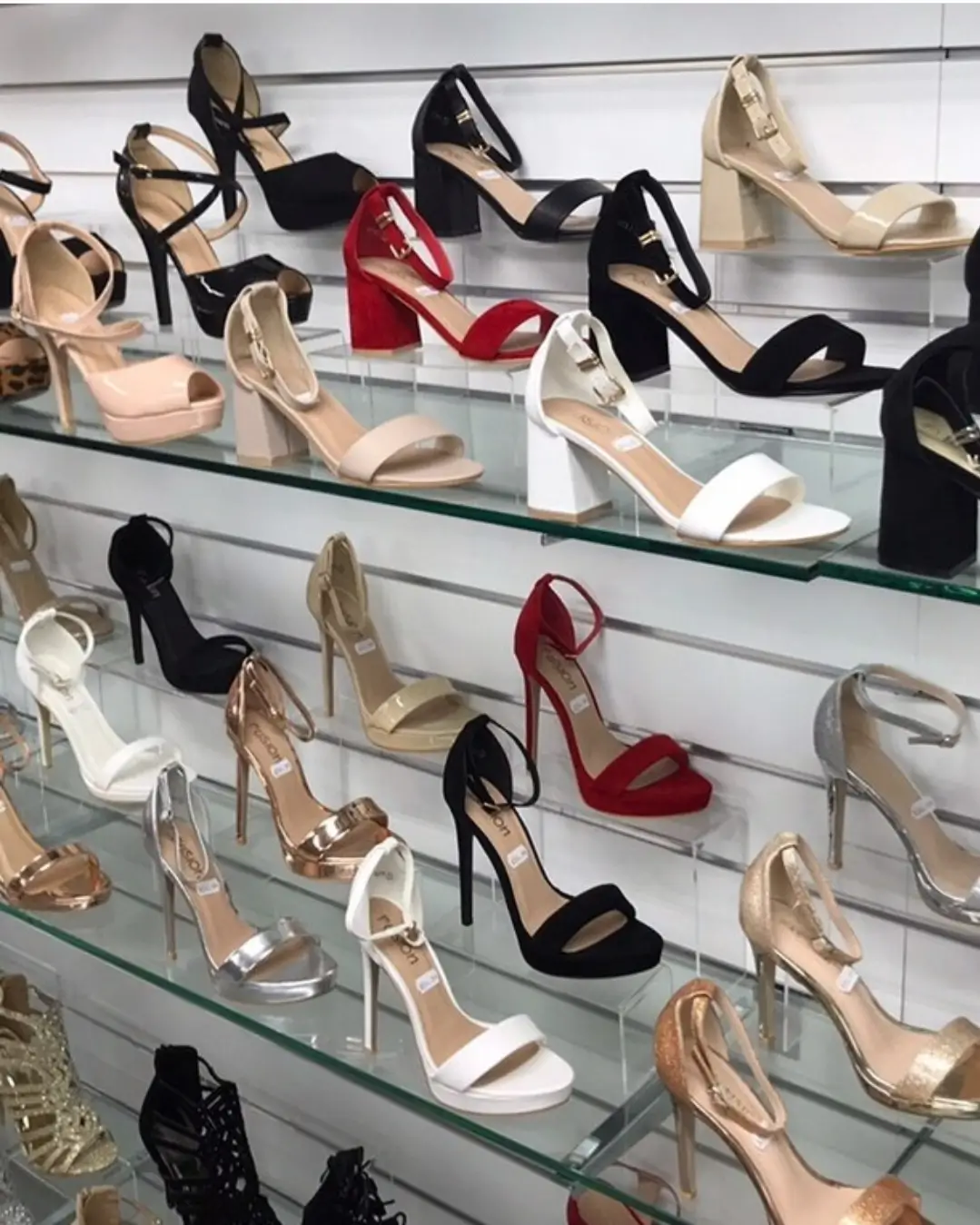 Shoes on glass shelves fitted to Dinya slatwall